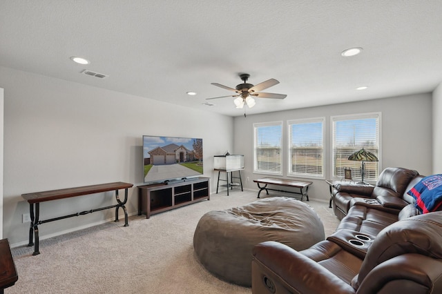 carpeted living room with a ceiling fan, recessed lighting, baseboards, and visible vents