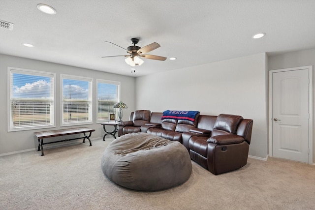 living room featuring light carpet, recessed lighting, and baseboards