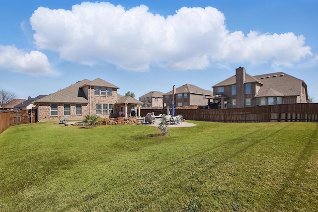 view of yard with a patio area and a fenced backyard