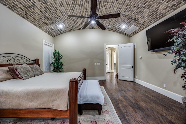 bedroom with hardwood / wood-style floors, lofted ceiling, brick ceiling, and baseboards