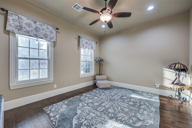 living area with recessed lighting, visible vents, baseboards, and wood finished floors