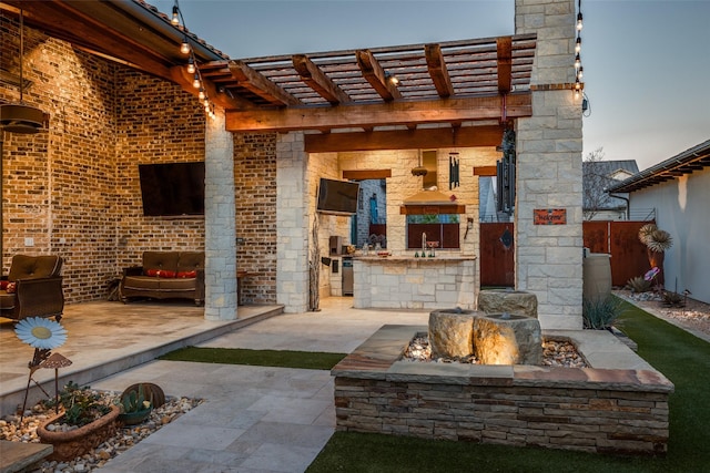 view of patio featuring a sink, an outdoor kitchen, and a pergola