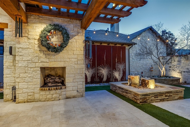 view of patio / terrace featuring an outdoor stone fireplace and a pergola