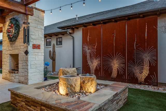 exterior space with an outdoor stone fireplace