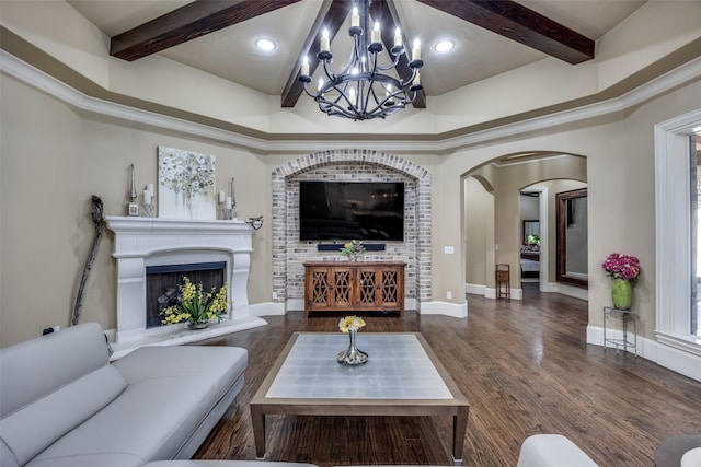 living room featuring beamed ceiling, wood finished floors, baseboards, and a fireplace with raised hearth