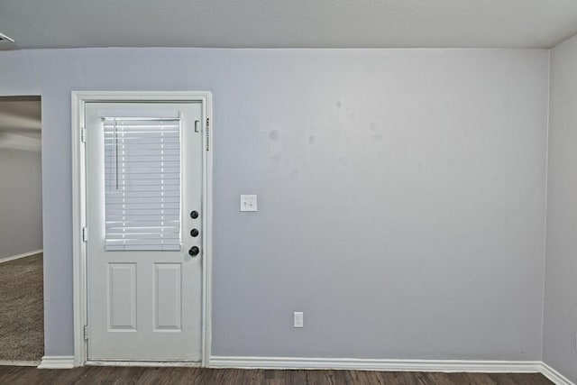 entryway with dark wood finished floors, visible vents, and baseboards