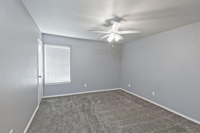 empty room with ceiling fan, baseboards, and carpet floors