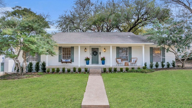 view of front of property with a front yard, covered porch, and roof with shingles