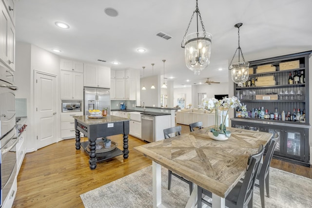 dining room featuring recessed lighting, visible vents, and light wood finished floors