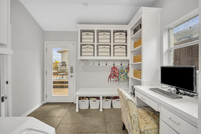 mudroom featuring tile patterned floors, baseboards, and built in study area