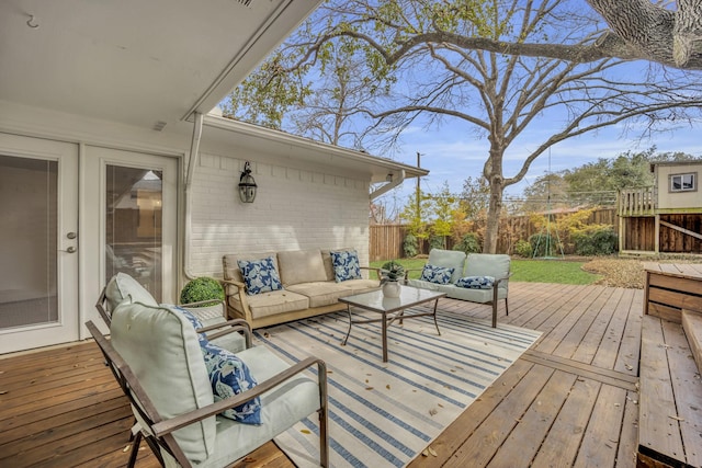 wooden terrace with an outdoor living space and a fenced backyard