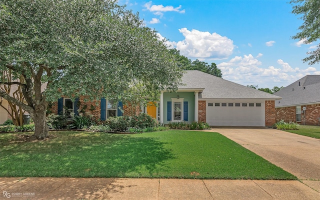 view of front of home featuring a front yard, a shingled roof, concrete driveway, a garage, and brick siding