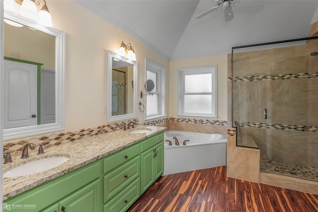 bathroom featuring wood finished floors, tiled shower, and a sink