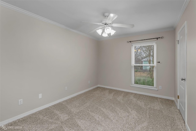 carpeted empty room featuring baseboards, ceiling fan, and ornamental molding