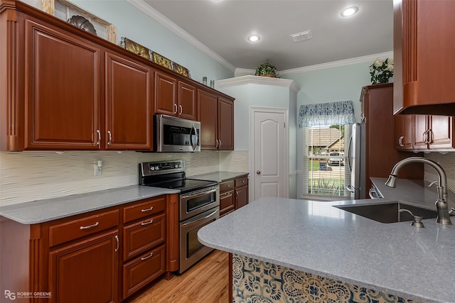 kitchen with visible vents, ornamental molding, a sink, tasteful backsplash, and appliances with stainless steel finishes