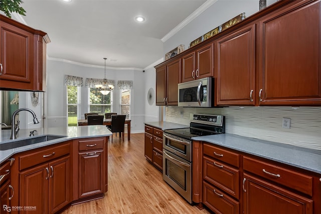 kitchen with ornamental molding, a sink, tasteful backsplash, light wood-style floors, and appliances with stainless steel finishes