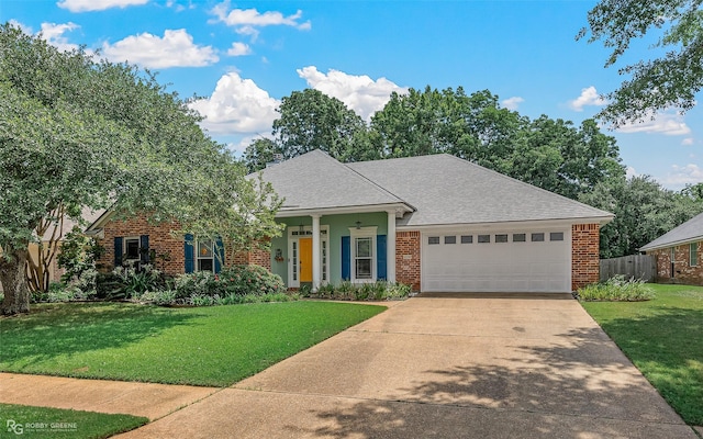 ranch-style house featuring driveway, fence, a front yard, a garage, and brick siding