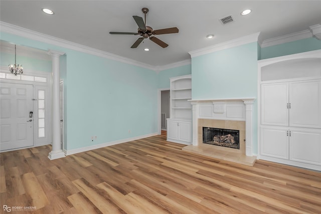 unfurnished living room featuring light wood-type flooring, visible vents, crown molding, baseboards, and ornate columns