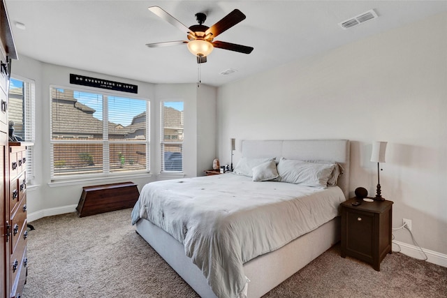 carpeted bedroom featuring a ceiling fan, baseboards, and visible vents