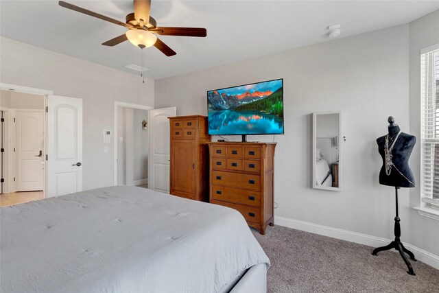 bedroom featuring a ceiling fan, light colored carpet, and baseboards