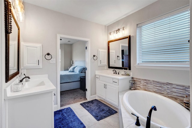 ensuite bathroom featuring two vanities, a sink, tile patterned flooring, ensuite bathroom, and a bath