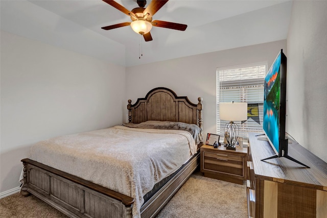 bedroom featuring light carpet, ceiling fan, and vaulted ceiling