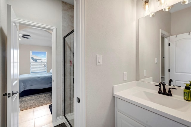 ensuite bathroom featuring tile patterned floors, ensuite bathroom, a shower stall, ceiling fan, and vanity