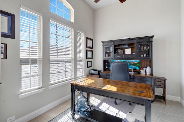 office area with baseboards and a ceiling fan