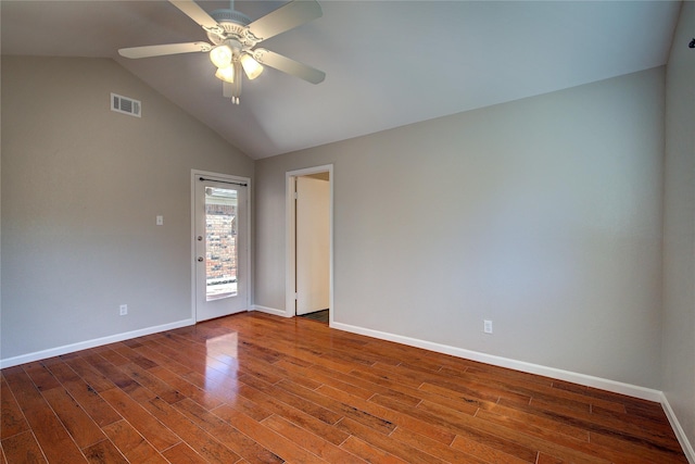 unfurnished room with lofted ceiling, wood finished floors, visible vents, and baseboards