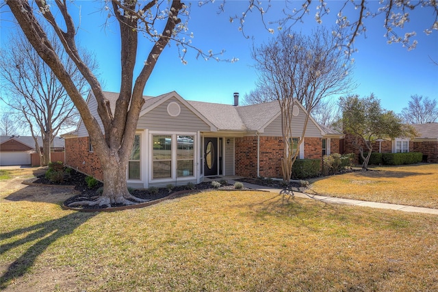 single story home featuring brick siding and a front lawn