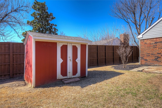 view of shed with a fenced backyard