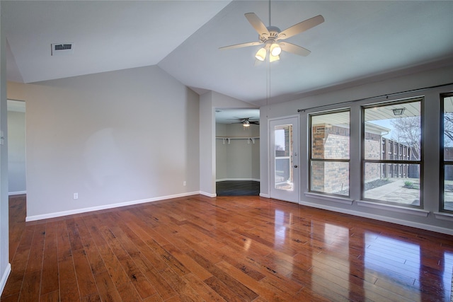 interior space with baseboards, wood-type flooring, and lofted ceiling