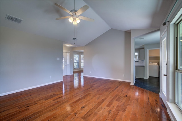 unfurnished living room with visible vents, washer / dryer, a ceiling fan, and hardwood / wood-style flooring