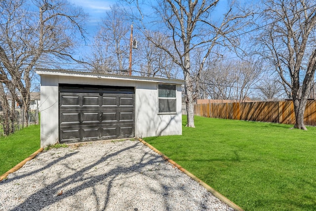 garage with driveway and fence