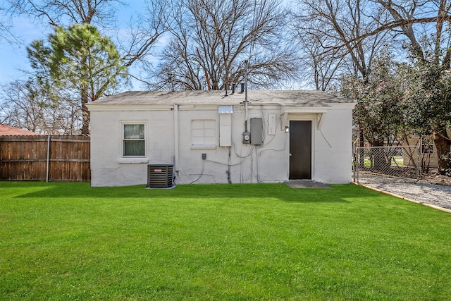 view of outbuilding with central air condition unit and fence