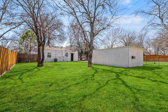 view of yard with an outbuilding and a fenced backyard