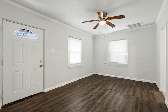 foyer featuring visible vents, baseboards, dark wood finished floors, and ornamental molding