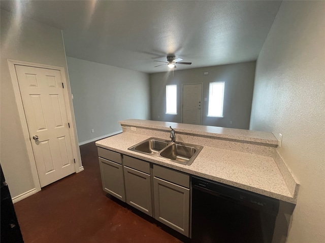 kitchen featuring a ceiling fan, gray cabinets, a sink, light countertops, and dishwashing machine