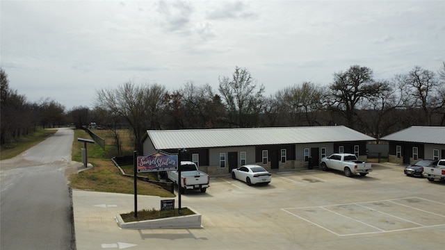 view of building exterior with uncovered parking