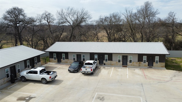 view of property featuring uncovered parking