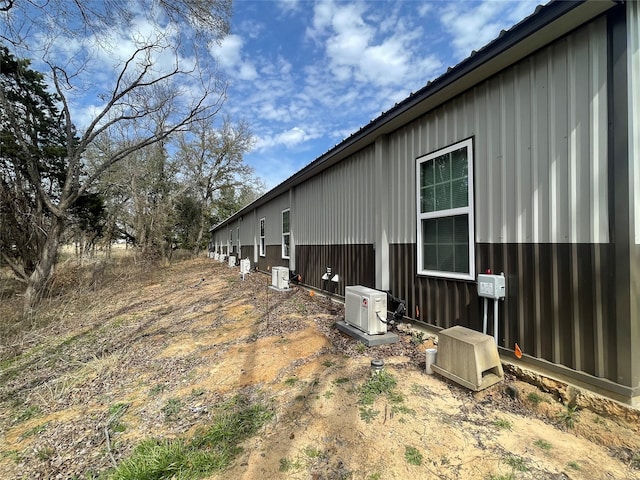 view of side of home with ac unit and central AC unit