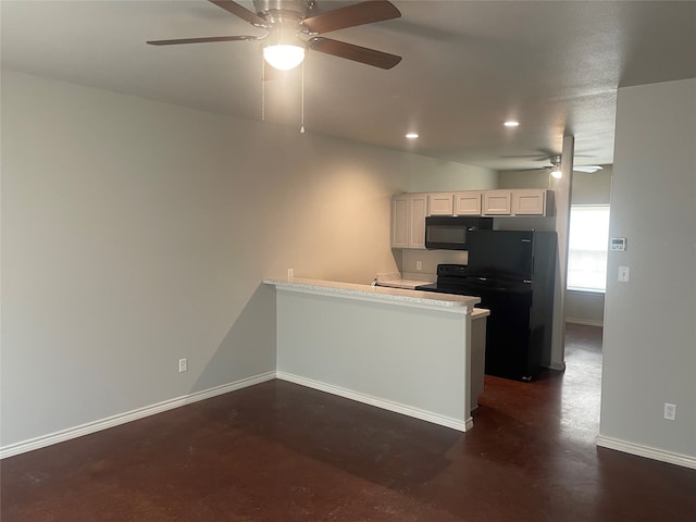 kitchen featuring baseboards, finished concrete floors, light countertops, a peninsula, and black appliances