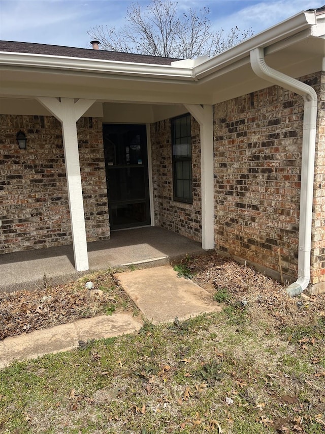 property entrance featuring brick siding