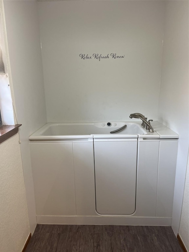 laundry area featuring dark wood-type flooring