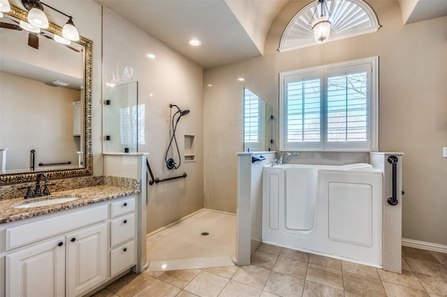 full bath featuring vanity, a garden tub, a walk in shower, and tile patterned floors