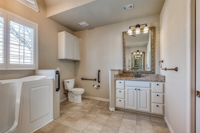 full bath with visible vents, baseboards, toilet, and vanity