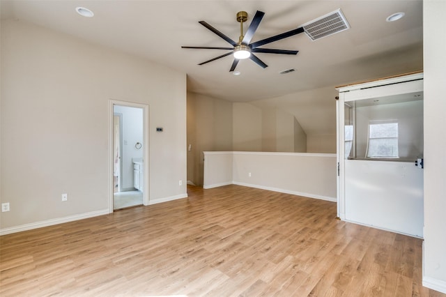 spare room featuring light wood-style flooring, baseboards, visible vents, and ceiling fan