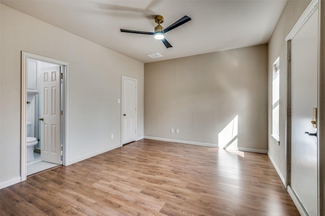 empty room with baseboards, a ceiling fan, and wood finished floors