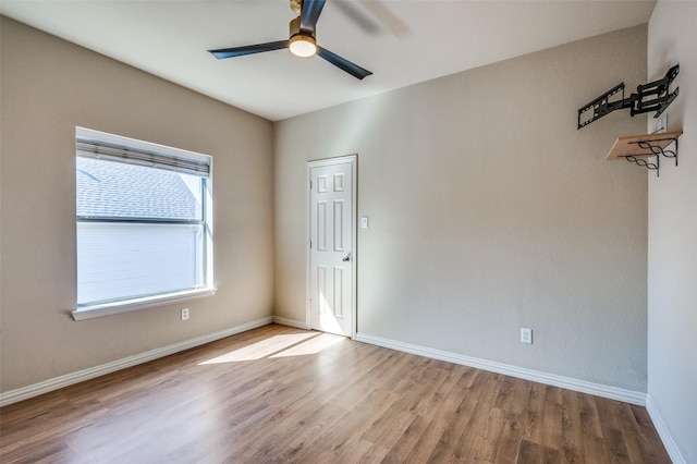 unfurnished room with ceiling fan, baseboards, and wood finished floors