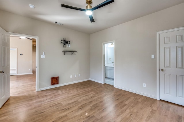 unfurnished bedroom with light wood-type flooring, visible vents, ensuite bath, baseboards, and ceiling fan